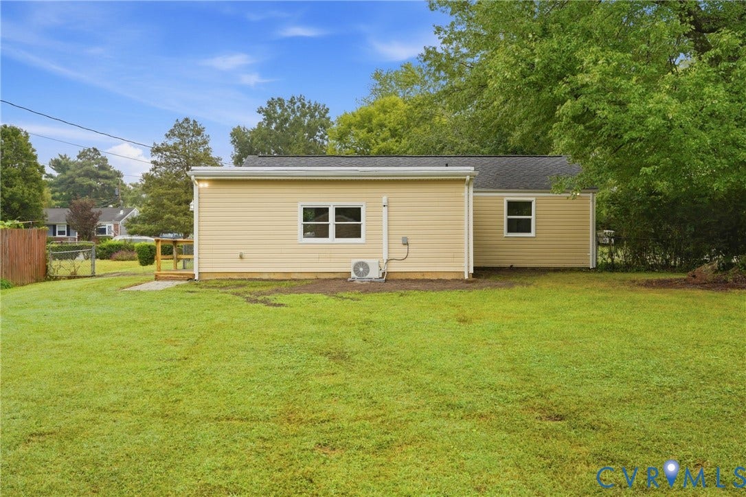 1814 Aeronca Avenue, Henrico, VA 23228 Expansive green lawn with a wood fence and a small wood-finish deck
