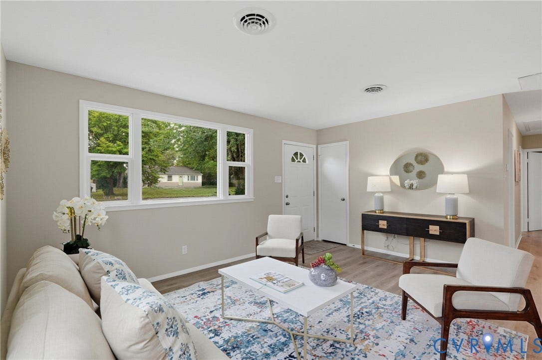 1814 Aeronca Avenue, Henrico, VA 23228 Neutral wall tones, wood-finish flooring, a multi-pane window, and a white entry door with a decorative glass insert