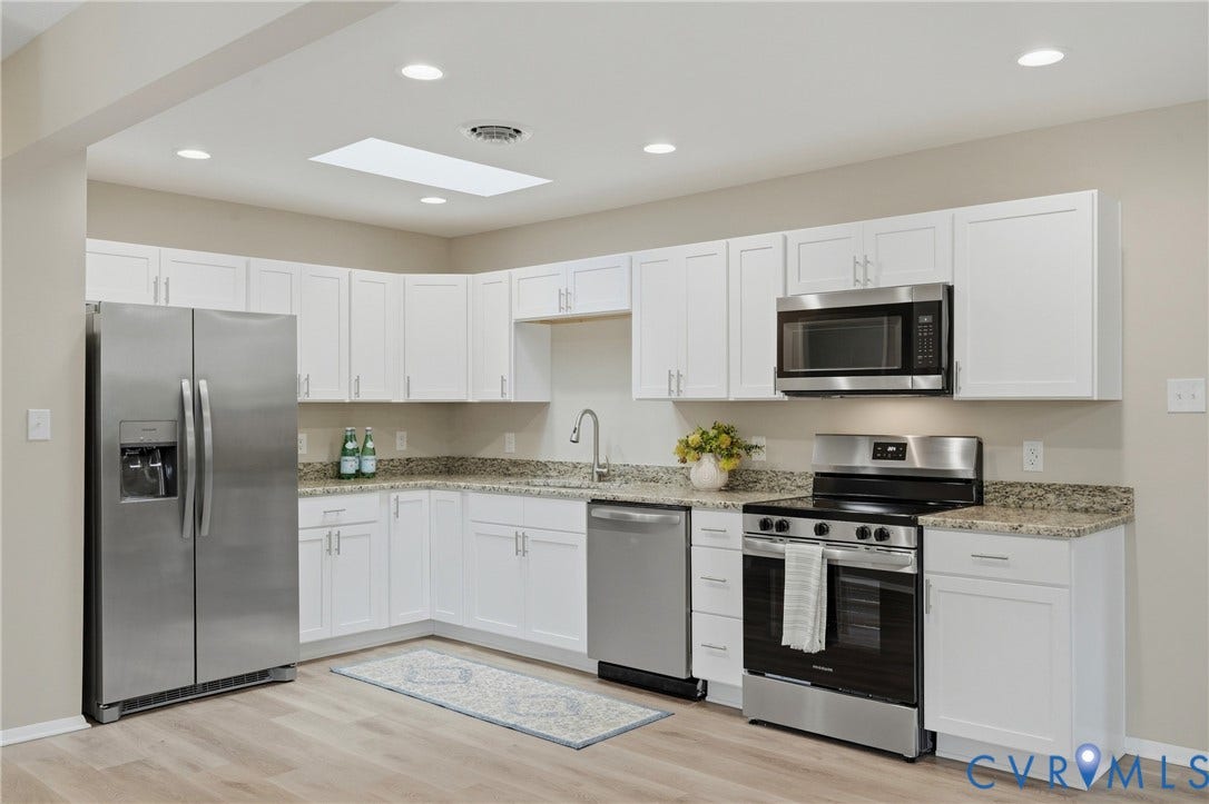 1814 Aeronca Avenue, Henrico, VA 23228 Kitchen featuring white cabinetry, stainless steel appliances, granite countertops, wood-finish flooring, and a skylight