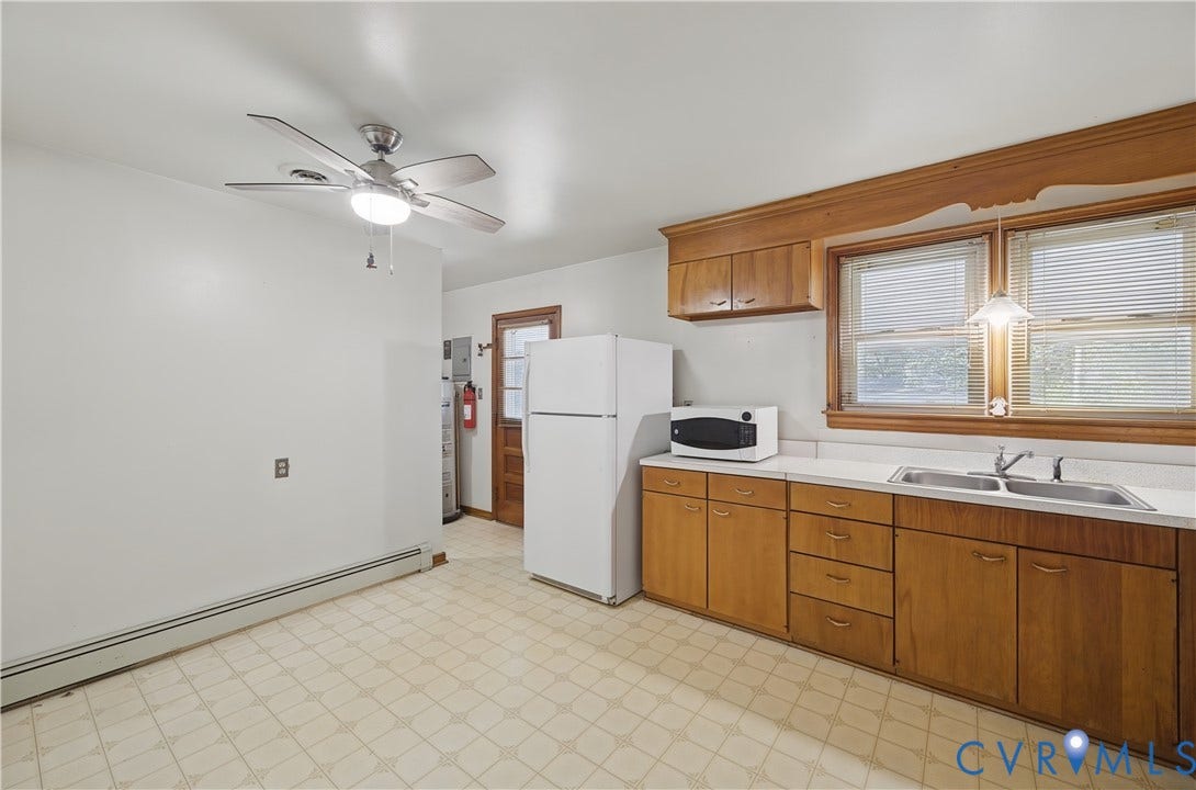 528 Duffton Road, Richmond, VA 23225 Spacious kitchen featuring wood-finish cabinetry, laminate countertops, and a stainless steel refrigerator