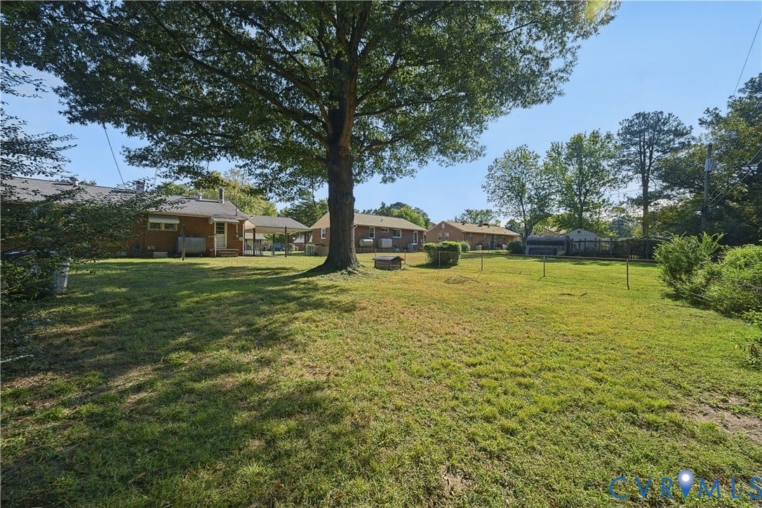 528 Duffton Road, Richmond, VA 23225 Expansive grounds featuring mature shade trees and lush lawn with multiple outbuildings, offering substantial acreage and versatile outdoor space