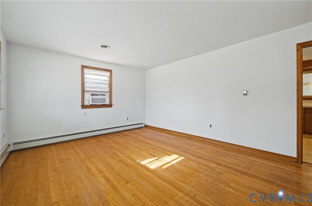 528 Duffton Road, Richmond, VA 23225 Hardwood flooring, painted walls, window with wood trim, and a window air conditioning unit