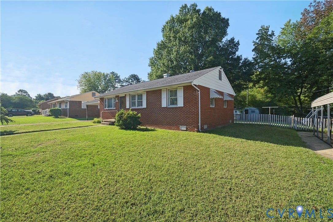 528 Duffton Road, Richmond, VA 23225 Brick exterior, white window shutters, front porch, mature trees, white picket fence