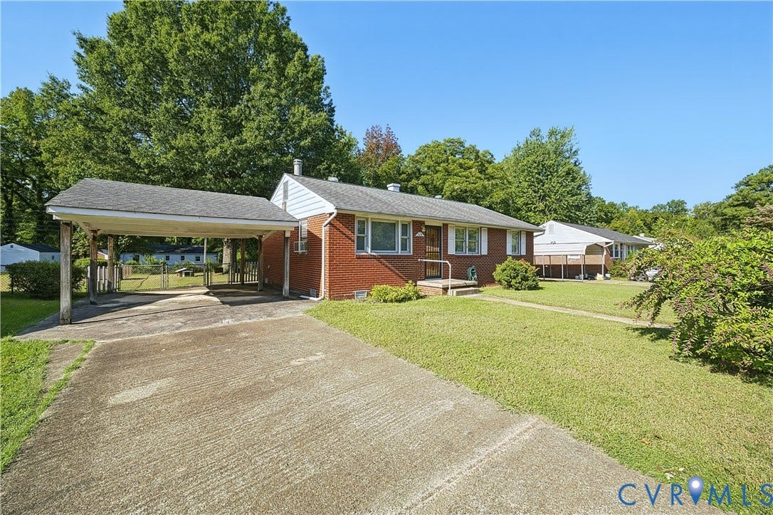 528 Duffton Road, Richmond, VA 23225 Brick exterior with carport, paved driveway, and established landscaping