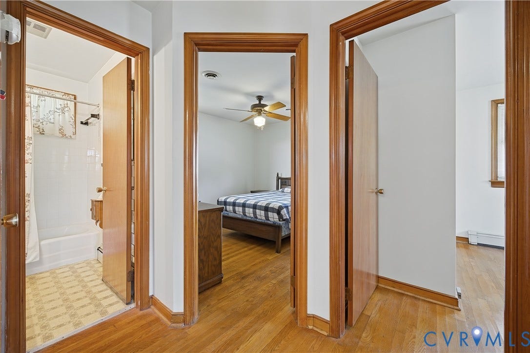 528 Duffton Road, Richmond, VA 23225 Hardwood wood-finish flooring throughout this hallway and adjoining spaces, framed by warm wood-trimmed doorways