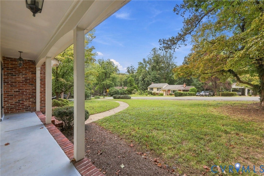 3238 E Weyburn Road, Bon Air, Richmond, VA 23235 Covered front porch with brick exterior, concrete flooring, and hanging lanterns