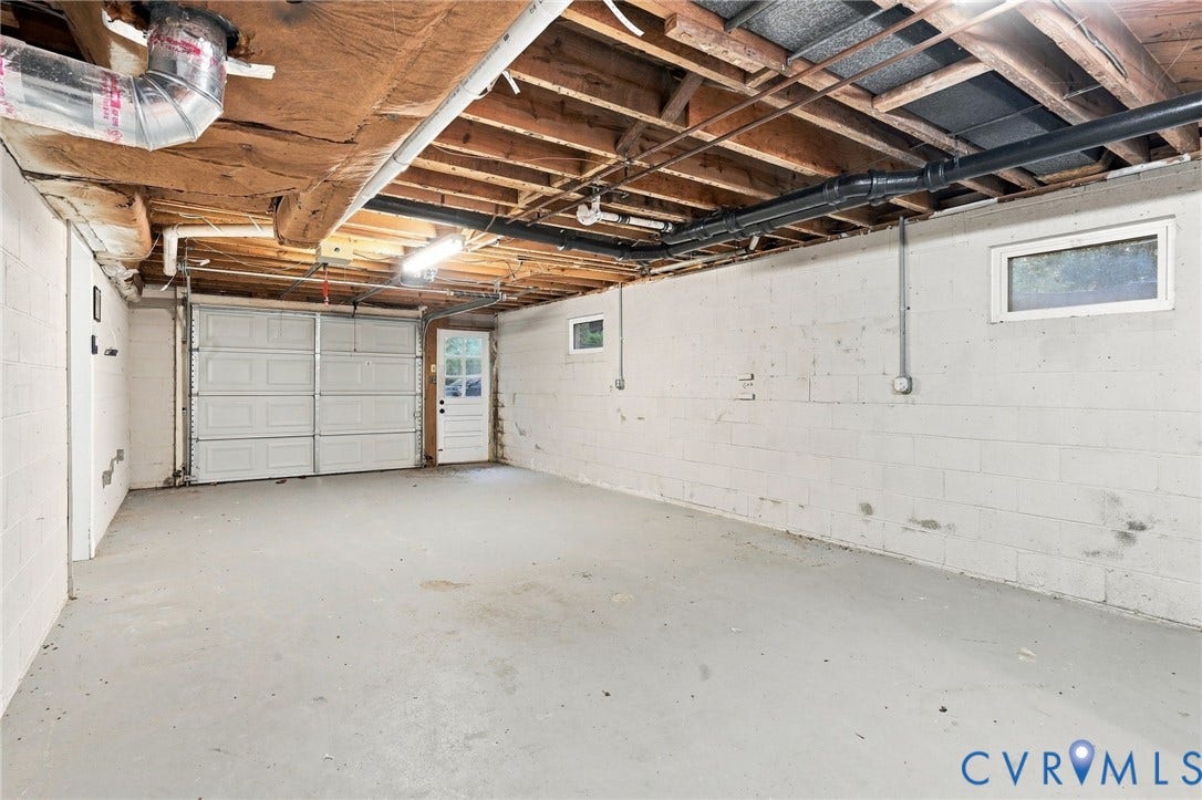 3238 E Weyburn Road, Bon Air, Richmond, VA 23235 Concrete flooring with a single garage door and a side entry door