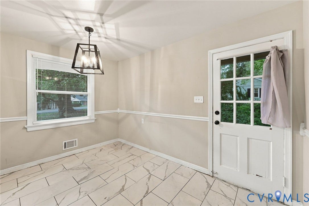 3238 E Weyburn Road, Bon Air, Richmond, VA 23235 Modern geometric chandelier, decorative chair rail molding, large window, white paneled door with glass inserts, and light-toned tile flooring