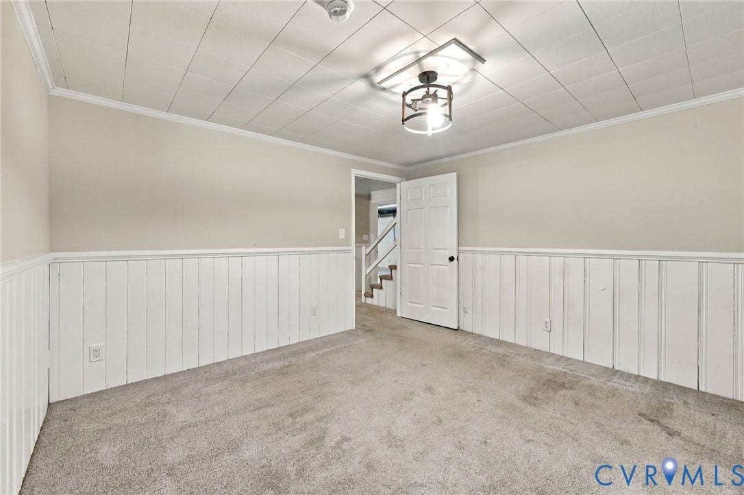 3238 E Weyburn Road, Bon Air, Richmond, VA 23235 Carpeted room featuring white wainscoting, crown molding, and a paneled ceiling with a semi-flush mount light fixture