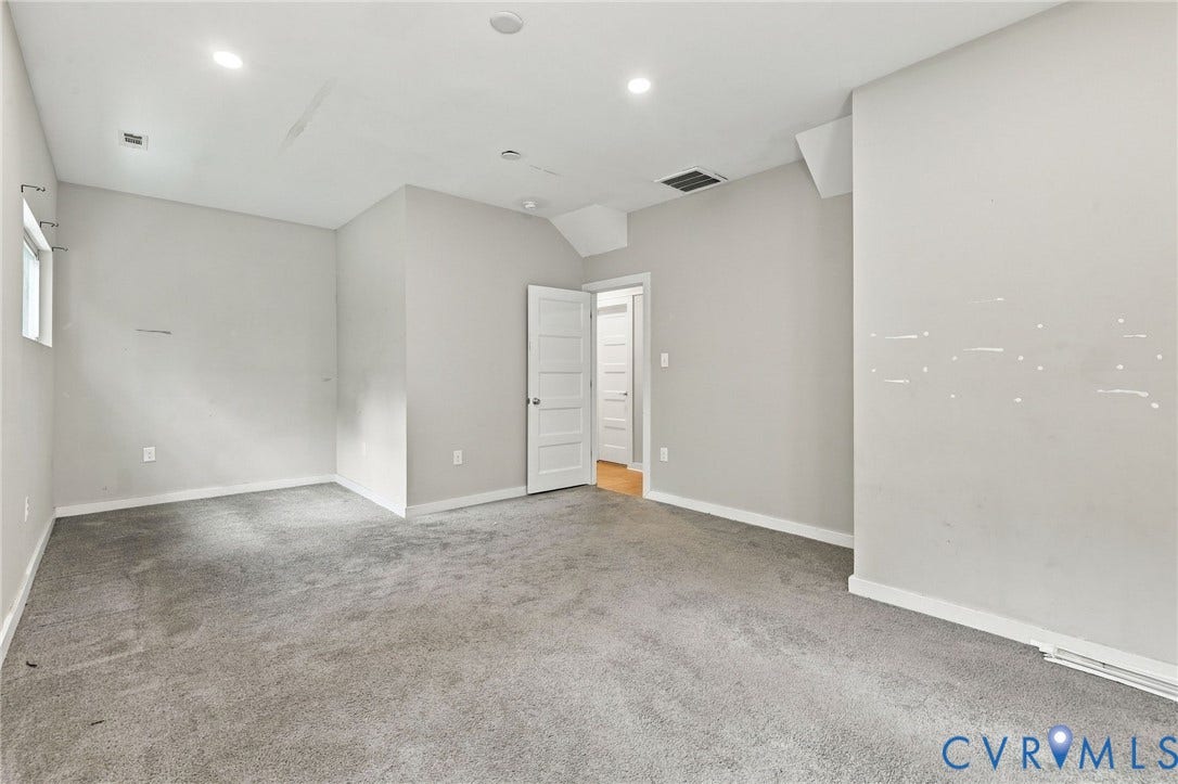 5824 Riverside Drive, Richmond, VA 23225 Spacious room featuring neutral carpeting, recessed lighting, a white paneled door, and a single window