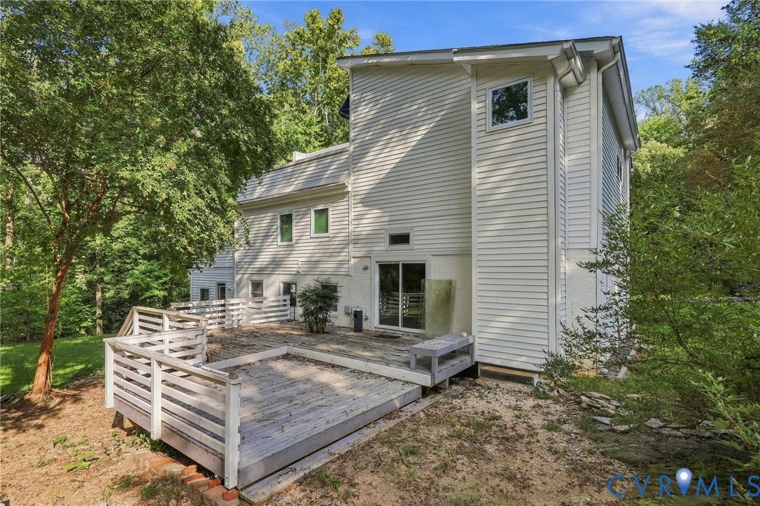 5824 Riverside Drive, Richmond, VA 23225 Exterior featuring white horizontal siding, a multi-level wooden deck with white railings, and mature surrounding trees