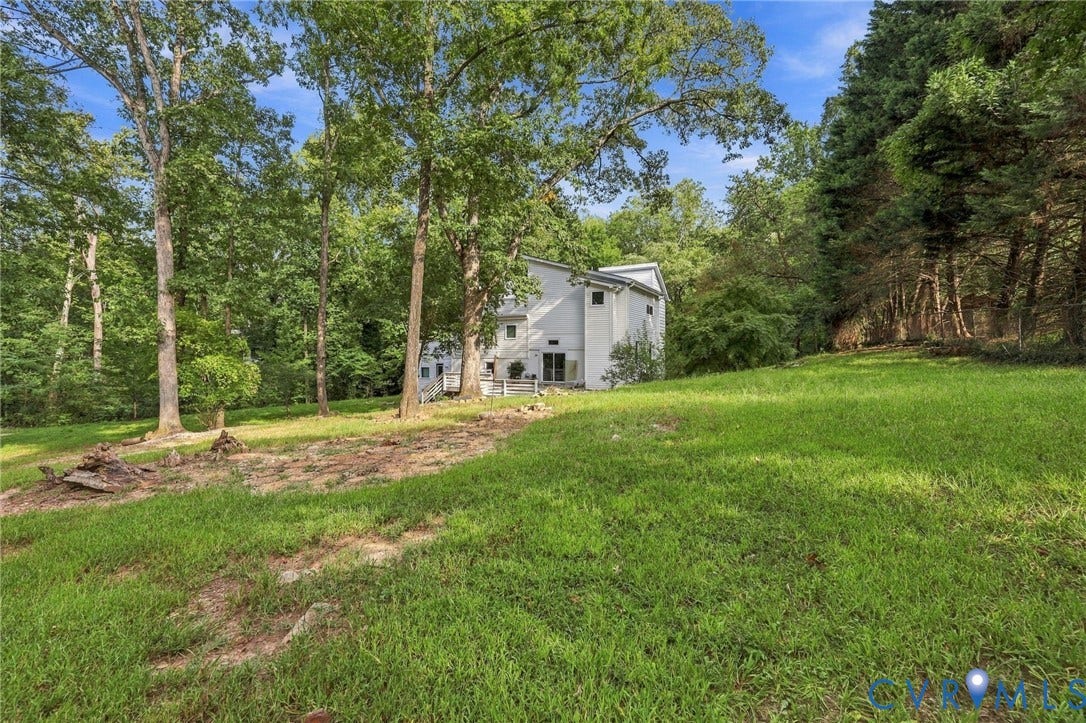 5824 Riverside Drive, Richmond, VA 23225 Expansive grassy yard with mature trees and a two-story residence