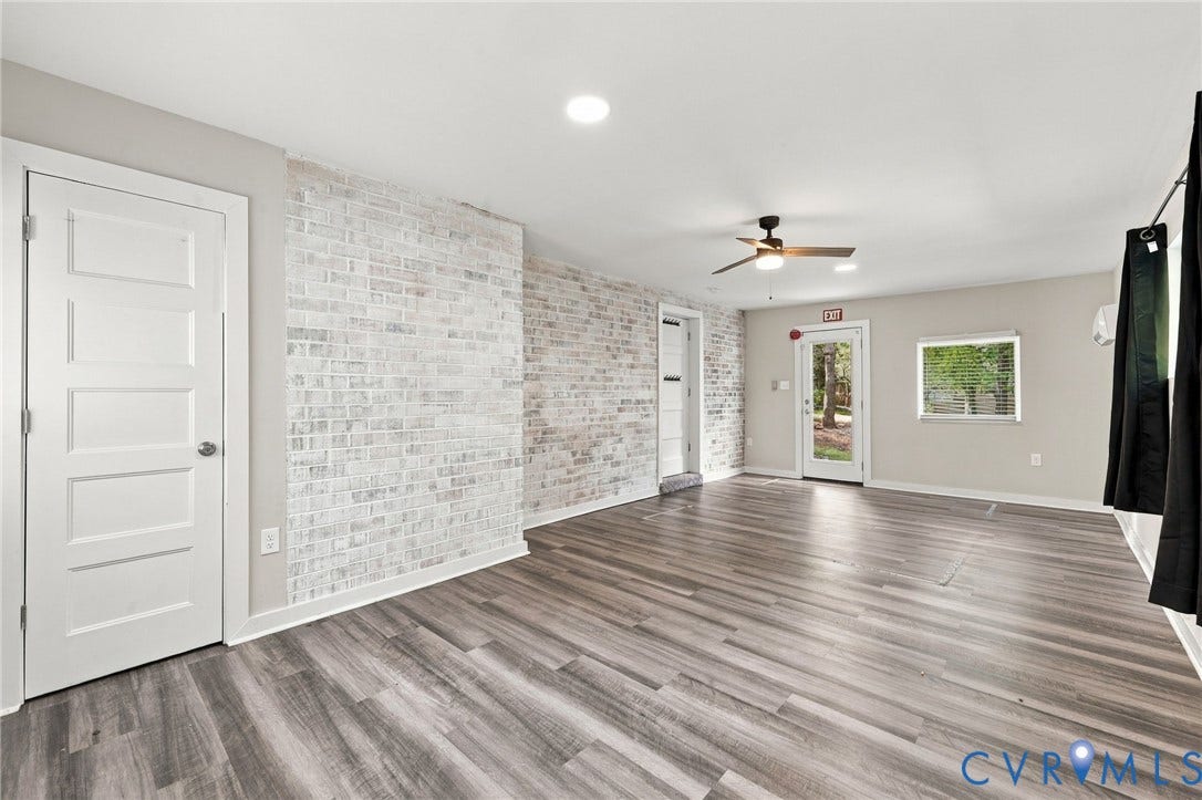 5824 Riverside Drive, Richmond, VA 23225 Wood-finish flooring, recessed lighting, ceiling fan, whitewashed brick accent wall, and multiple entry points