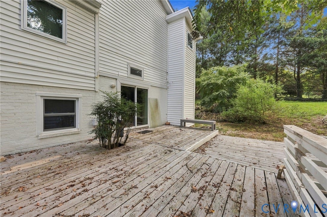 5824 Riverside Drive, Richmond, VA 23225 Multi-level wood deck with sliding glass door access, white siding exterior, and mature landscaping