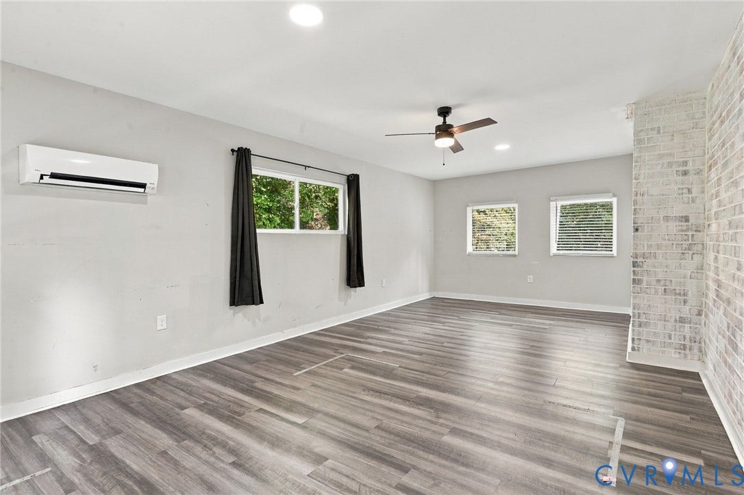 5824 Riverside Drive, Richmond, VA 23225 Wood-finish flooring, white painted brick accent wall, recessed lighting, and ceiling fan