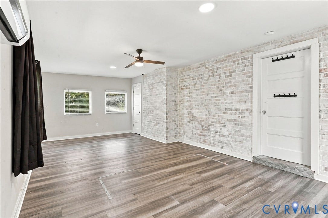 5824 Riverside Drive, Richmond, VA 23225 Wood-finish flooring throughout, complemented by a distressed brick-finish accent wall