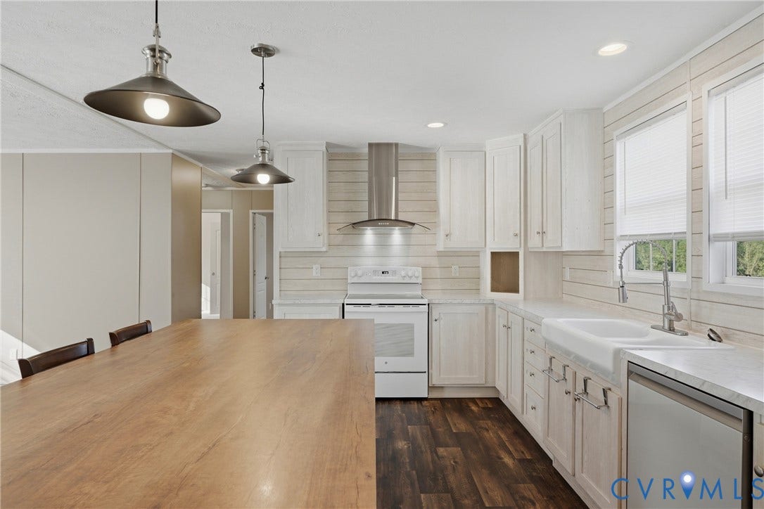 1385 Waltons Store Road, Hadensville North, Louisa, VA 23093 White shaker cabinetry, wood-finish flooring, recessed lighting, and a farmhouse sink with a stainless steel faucet