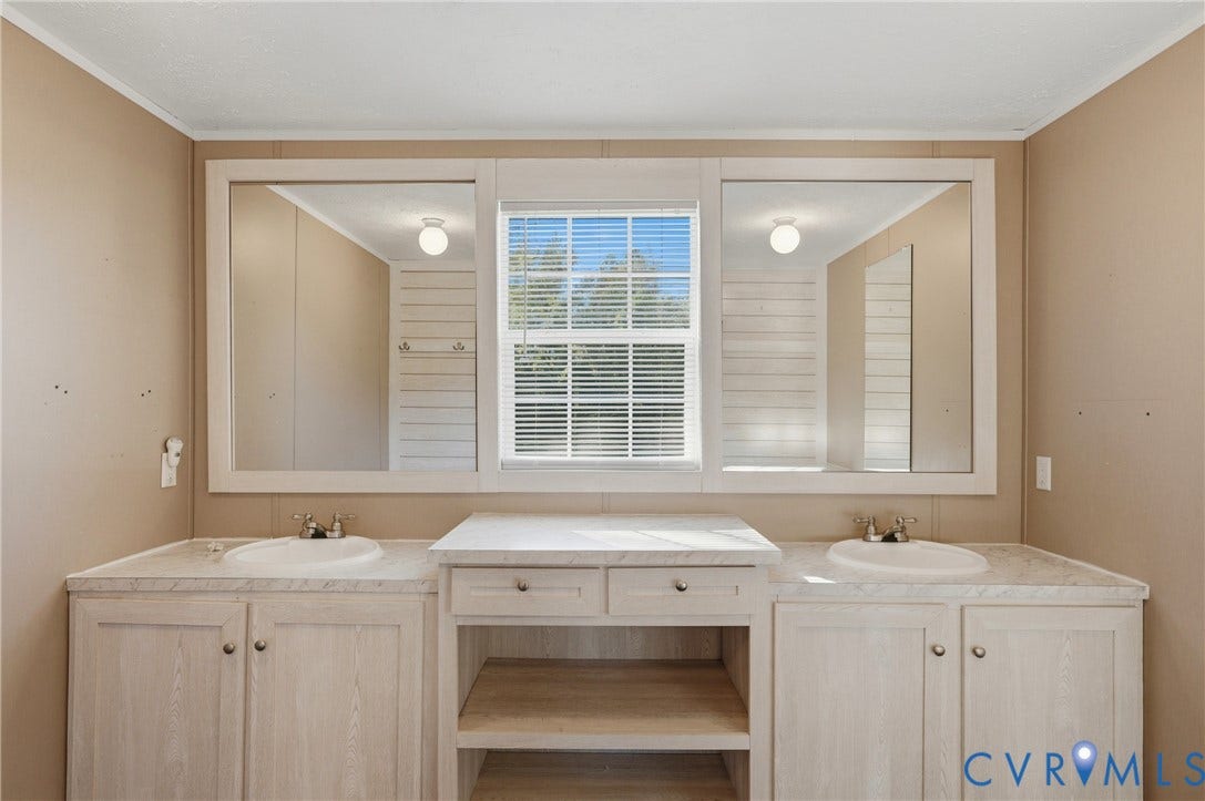 1385 Waltons Store Road, Hadensville North, Louisa, VA 23093 Double vanity with integrated sinks, framed mirrors, and a central window with blinds