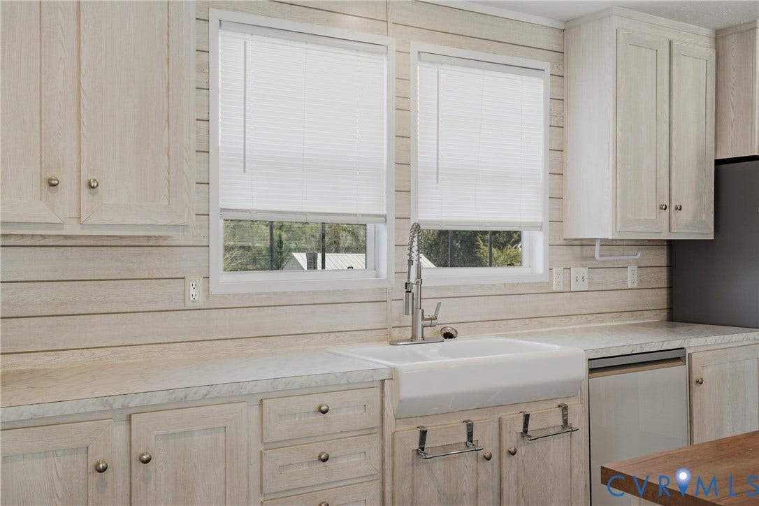 1385 Waltons Store Road, Hadensville North, Louisa, VA 23093 White farmhouse sink with a gooseneck faucet, light-toned cabinetry, and complementary countertops