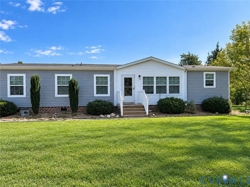 1385 Waltons Store Road, Hadensville North, Louisa, VA 23093 Single-story exterior with siding, a front porch with white railings, and mature landscaping