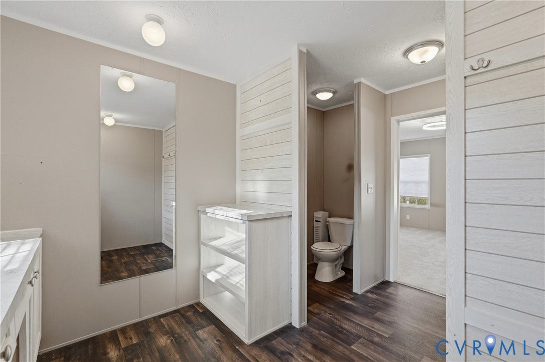 1385 Waltons Store Road, Hadensville North, Louisa, VA 23093 Wood-finish flooring, white shiplap accent wall, built-in shelving, and recessed lighting