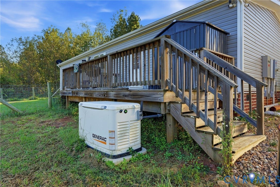 1385 Waltons Store Road, Hadensville North, Louisa, VA 23093 Exterior decking with staircase, a Generac whole-house generator, and a side access door