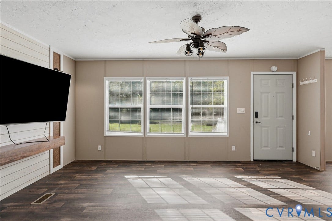 1385 Waltons Store Road, Hadensville North, Louisa, VA 23093 Wood-finish flooring, three transom windows, a ceiling fan with light fixture, and a built-in wood shelf