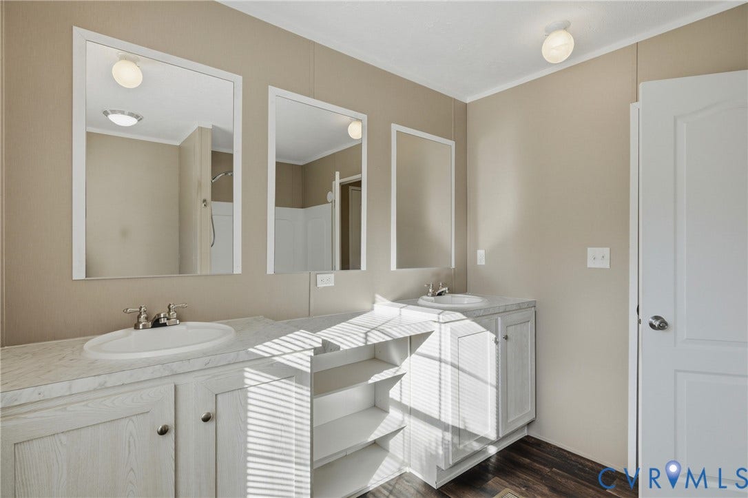 1385 Waltons Store Road, Hadensville North, Louisa, VA 23093 Dual vanities with integrated sinks, white cabinetry, and wood-finish flooring