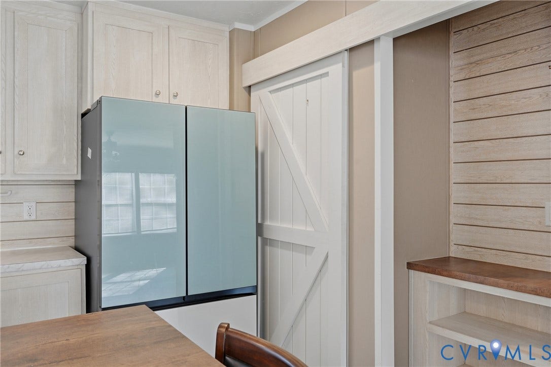 1385 Waltons Store Road, Hadensville North, Louisa, VA 23093 White shaker cabinetry, modern refrigerator, wood-finish countertops, shiplap accent wall, and built-in shelving