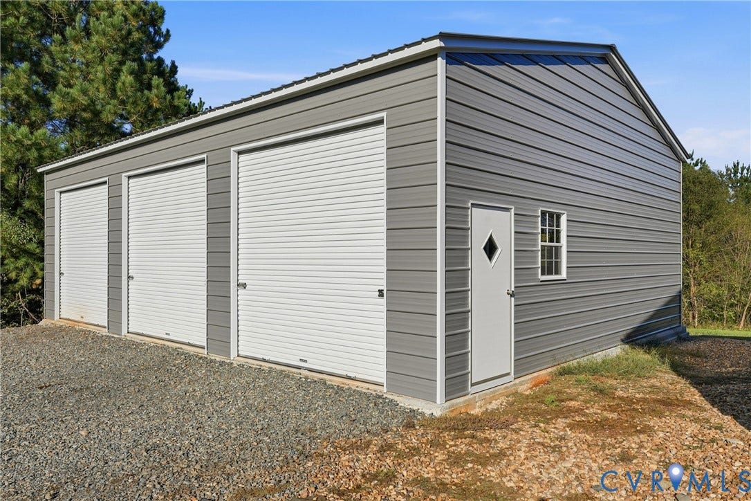 1385 Waltons Store Road, Hadensville North, Louisa, VA 23093 Metal exterior structure with three roll-up garage doors, a pedestrian entry door, and a single window
