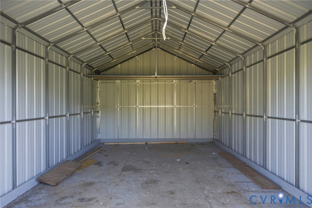 1385 Waltons Store Road, Hadensville North, Louisa, VA 23093 Metal-clad interior with corrugated walls and ceiling, featuring exposed structural framing and a concrete floor