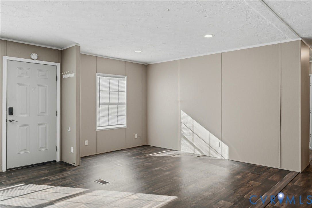 1385 Waltons Store Road, Hadensville North, Louisa, VA 23093 Dark wood-finish flooring, recessed ceiling lighting, light-toned wall panels, and a paneled entry door with dark hardware