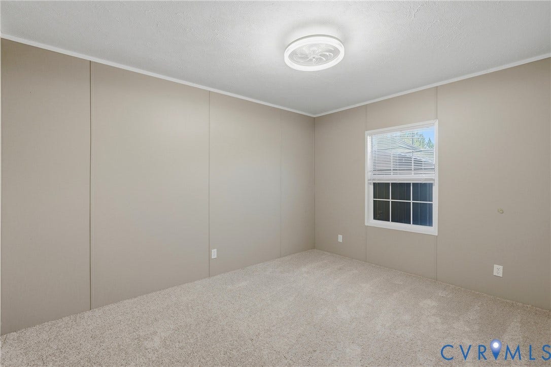 1385 Waltons Store Road, Hadensville North, Louisa, VA 23093 Carpeted flooring, neutral wall paneling, a single window with blinds, and a flush-mount ceiling light