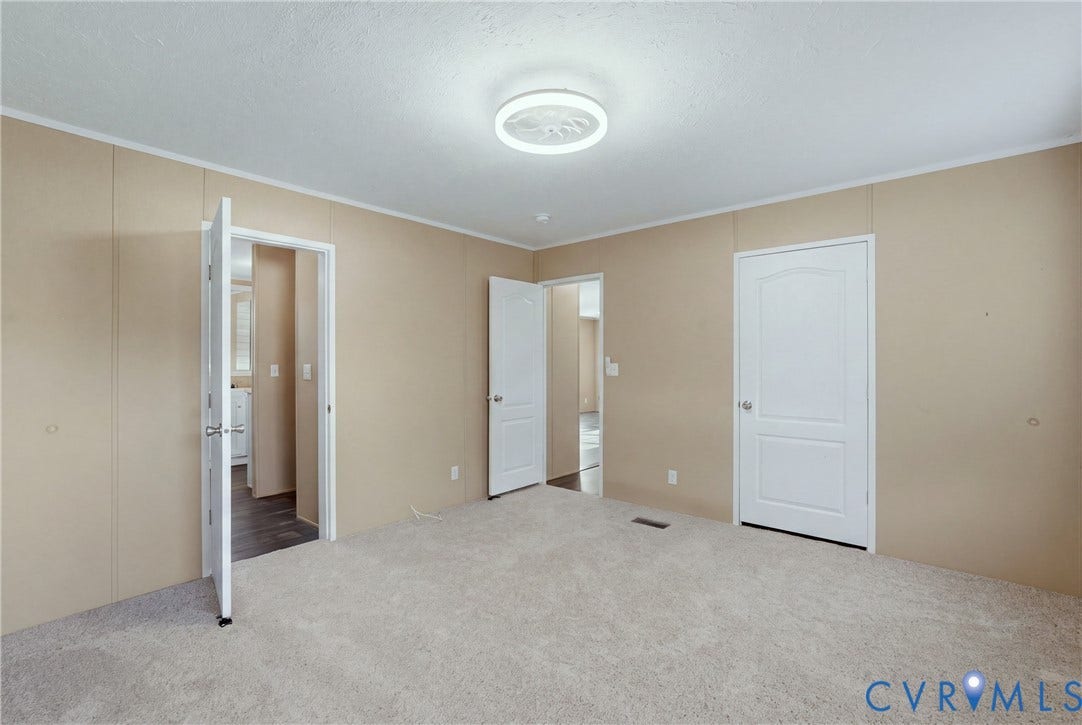 1385 Waltons Store Road, Hadensville North, Louisa, VA 23093 Neutral-toned walls with paneling, light-colored carpeting, white interior doors, and an overhead flush-mount light fixture