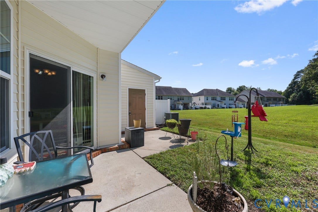 Concrete patio with a sliding glass door and an exterior storage shed