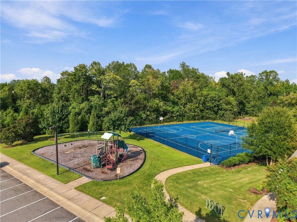 Recreational amenities featuring a playground, multi-sport court, walking paths, and bicycle racks