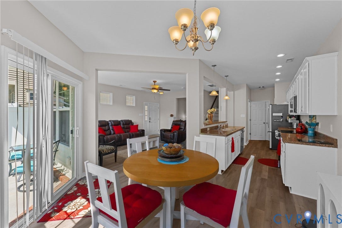Kitchen featuring white cabinetry, light-toned countertops, and wood-finish flooring