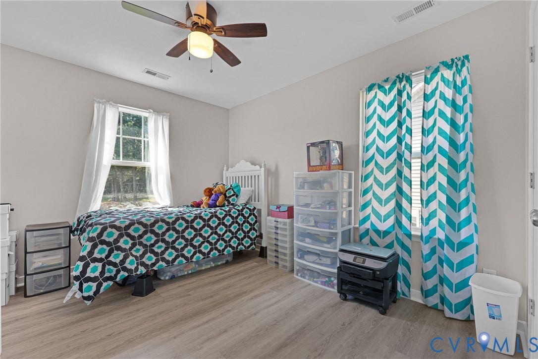 Wood-finish flooring, single window with white trim, ceiling fan with integrated lighting, recessed lighting, and light-toned wall paint