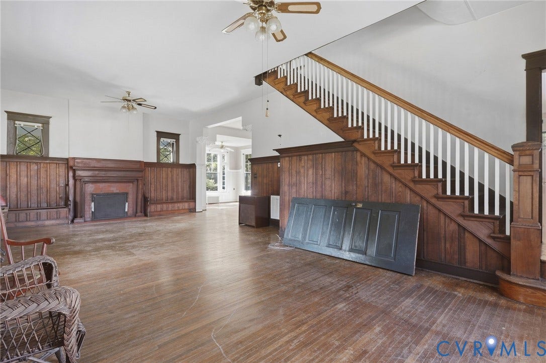 216 W Roanoke Street, Richmond, VA 23225 Hardwood flooring, wood paneling, ornate fireplace, staircase with white balusters, and ceiling fans
