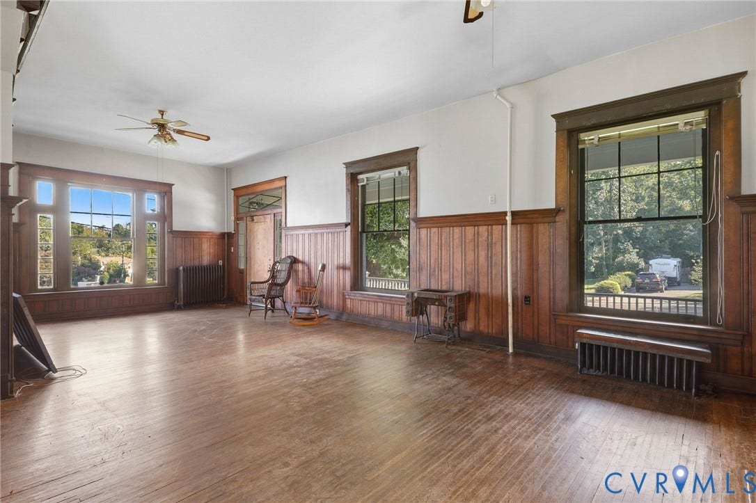 216 W Roanoke Street, Richmond, VA 23225 Hardwood flooring, wood paneling, decorative window trim, a large picture window, and a ceiling fan