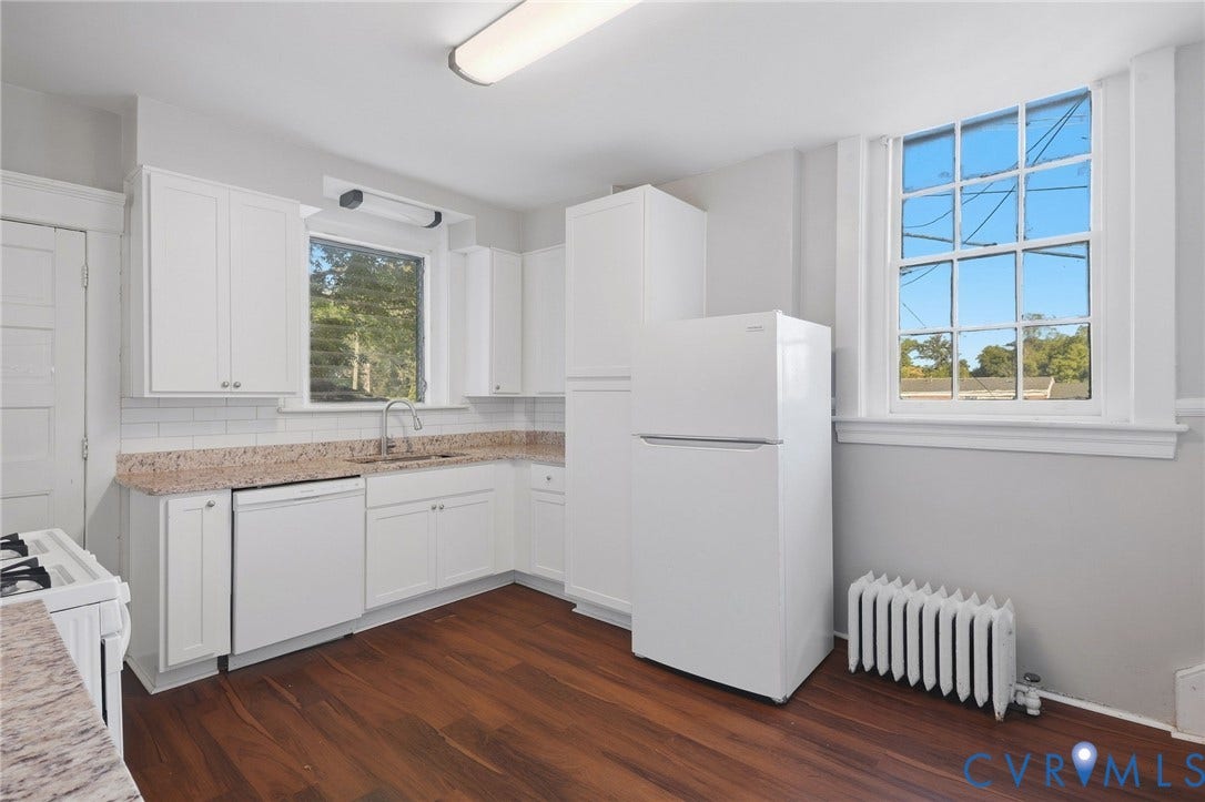 216 W Roanoke Street, Richmond, VA 23225 Kitchen featuring white cabinetry, granite-look countertops, white subway tile backsplash, wood-finish flooring, and a large multi-pane window