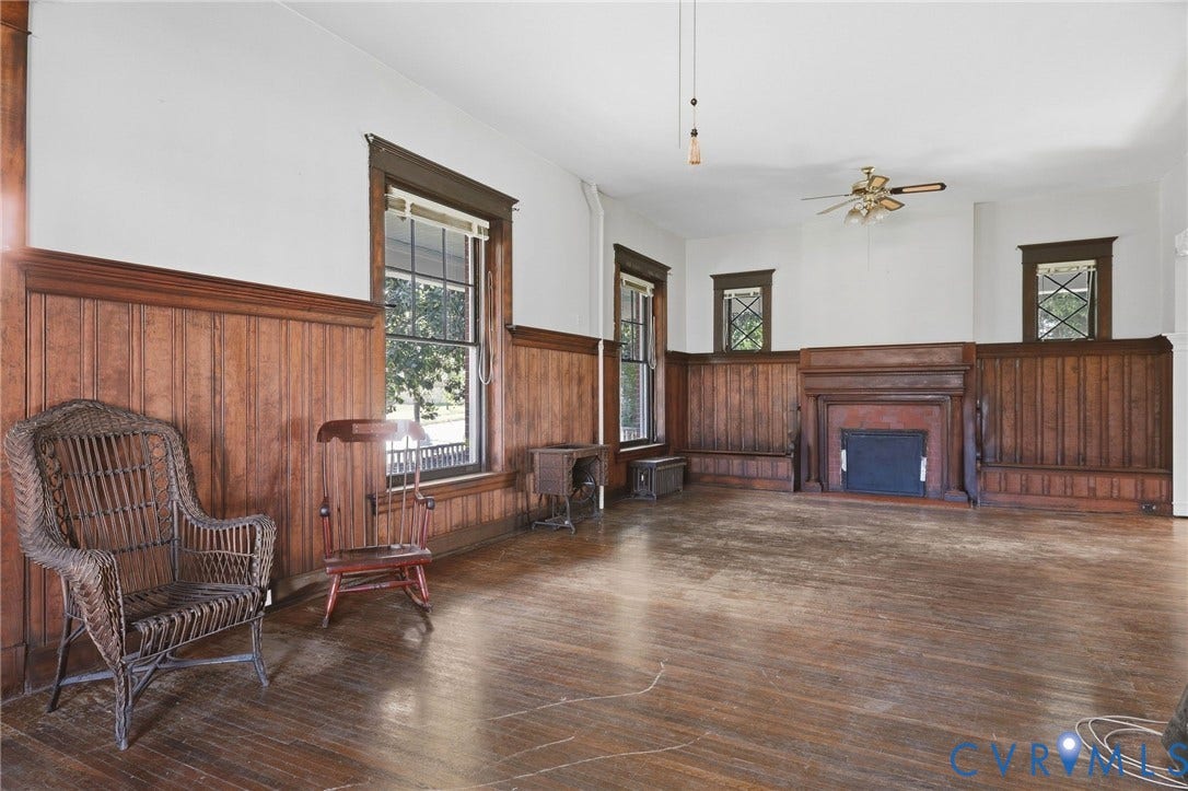 216 W Roanoke Street, Richmond, VA 23225 Wood-finish flooring, wood paneling, decorative fireplace, multiple windows, and a ceiling fan