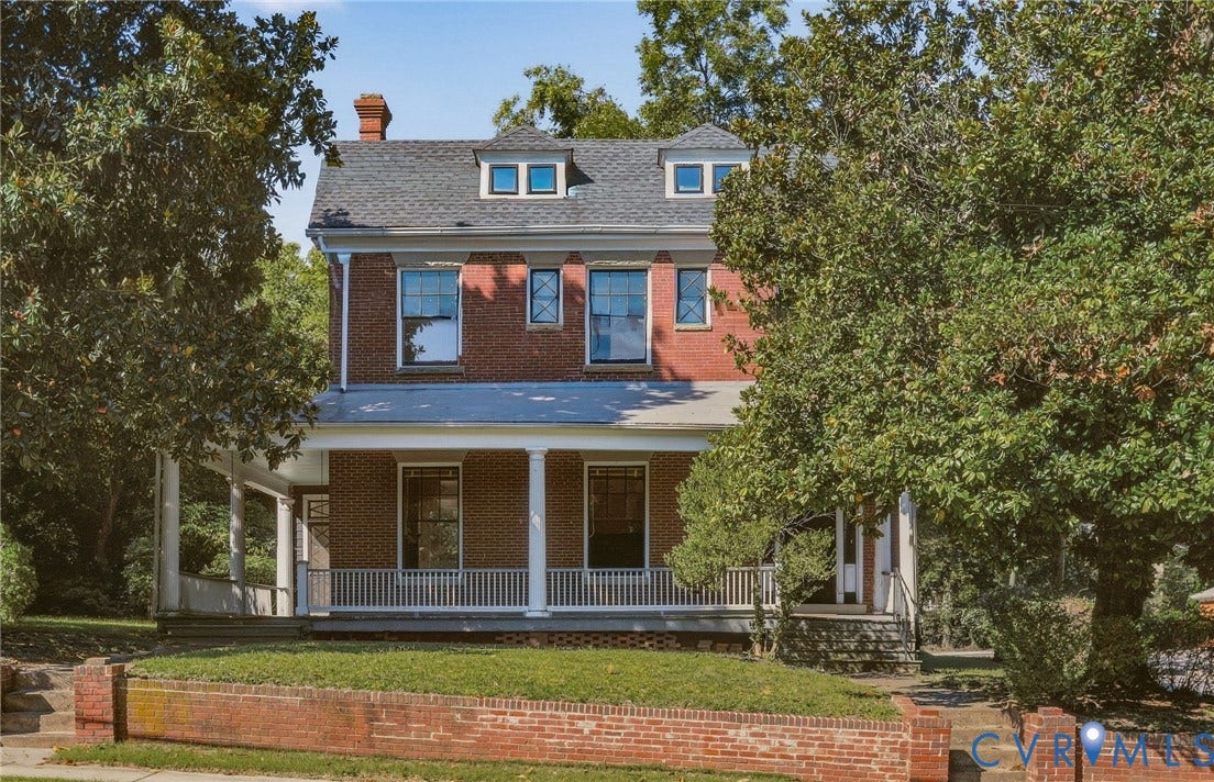 216 W Roanoke Street, Richmond, VA 23225 Two-story brick exterior featuring a covered front porch with white columns, dormer windows, and a brick retaining wall