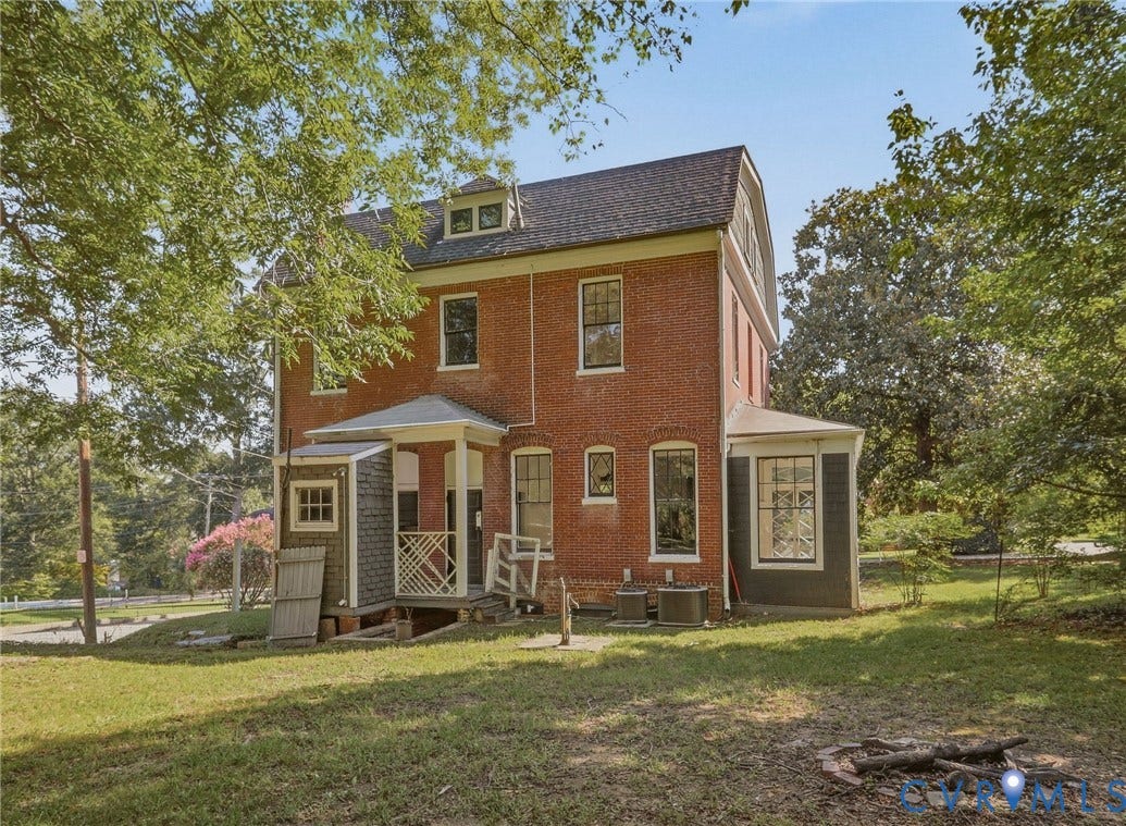 216 W Roanoke Street, Richmond, VA 23225 Brick exterior with multiple dormer windows, covered entry porch, and a side-mounted HVAC unit