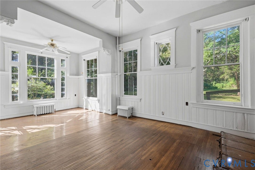 216 W Roanoke Street, Richmond, VA 23225 Hardwood flooring, paneled wainscoting, multiple large windows, window trim detail, and ceiling fans