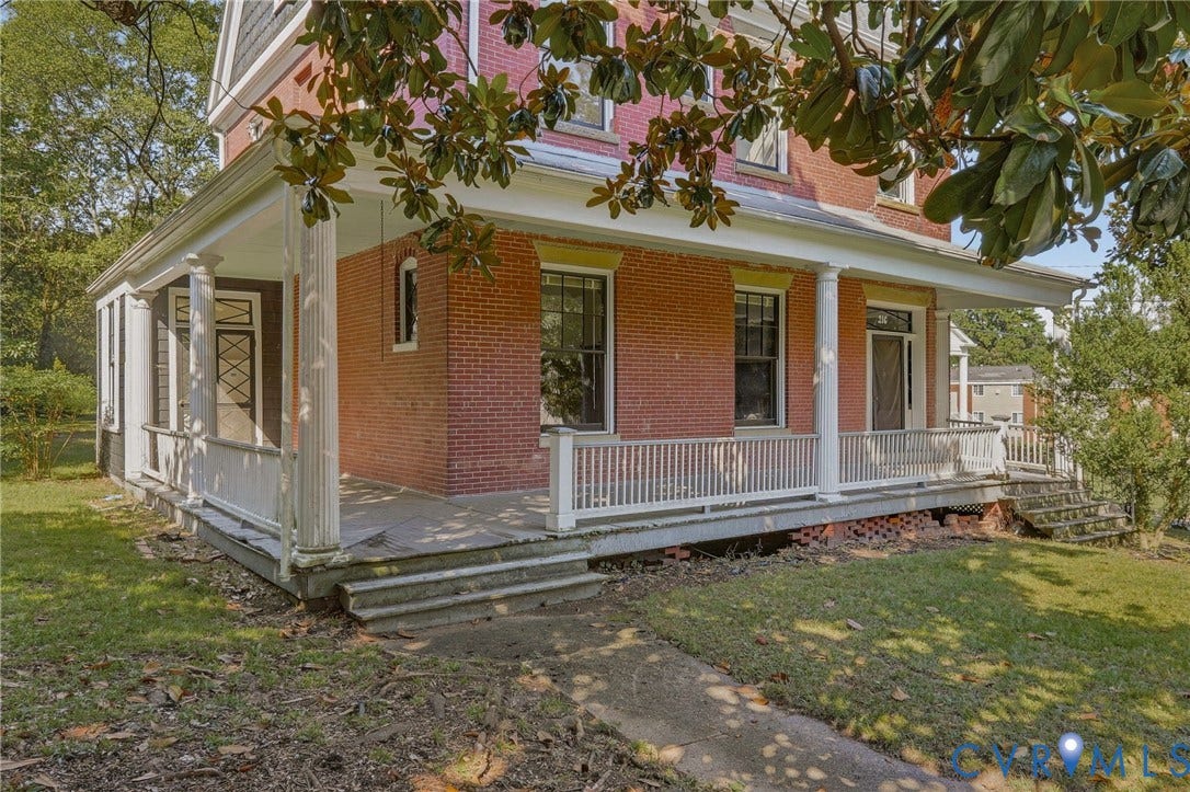 216 W Roanoke Street, Richmond, VA 23225 Brick exterior with a covered front porch, white columns, and white railing