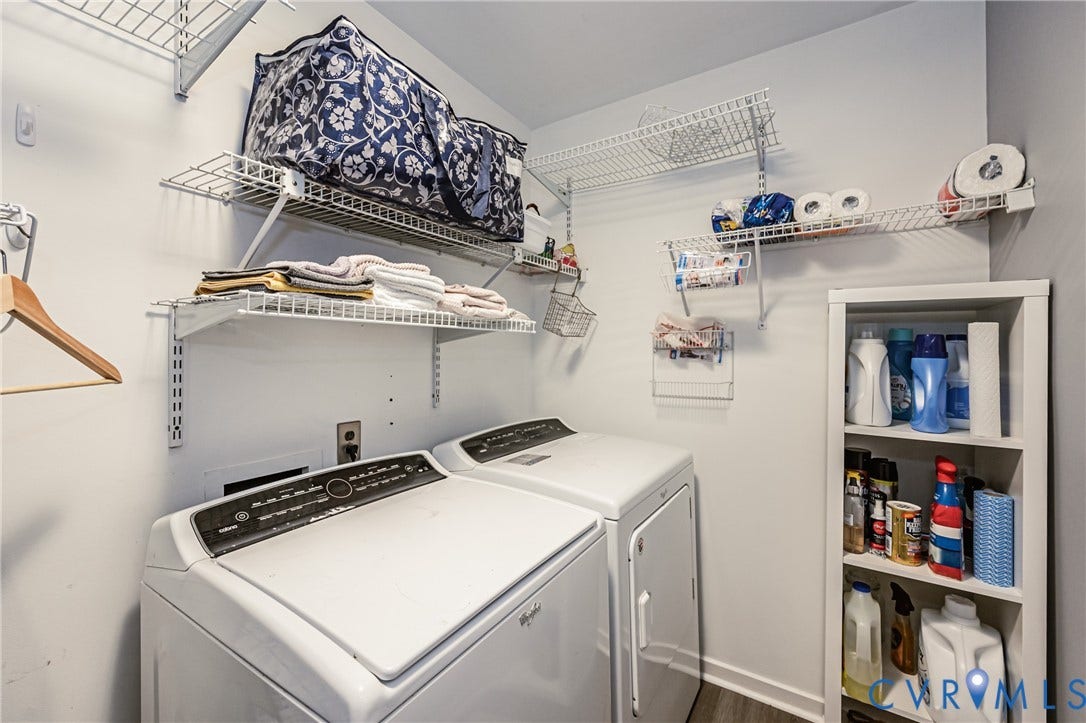 Utility area featuring white walls, wire shelving, and a built-in storage unit