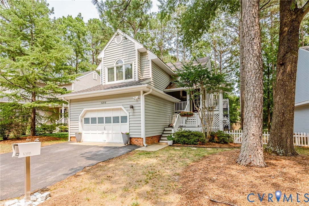 Light gray siding exterior with a white garage door