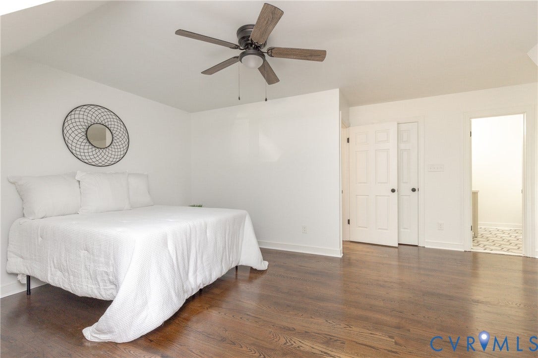 10541 Glencoe Road, Henrico, VA 23060 Dark wood-finish flooring with white baseboards and a ceiling fan with light fixture