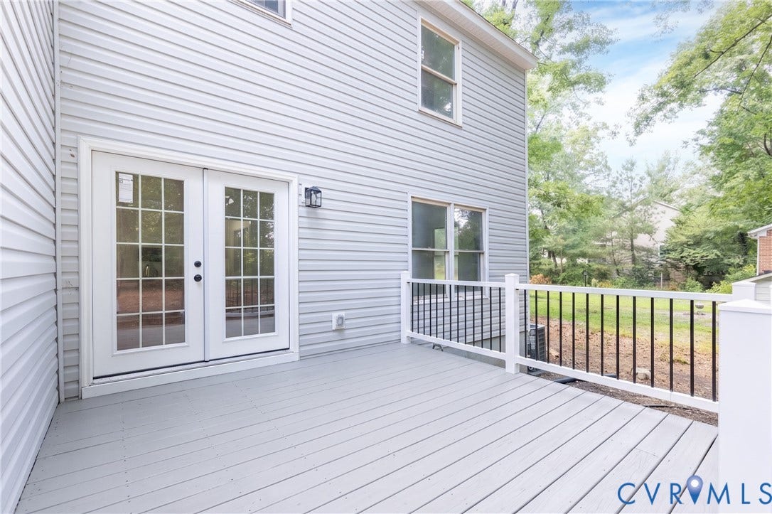 10541 Glencoe Road, Henrico, VA 23060 Exterior deck featuring white railings, black balusters, and a light gray surface